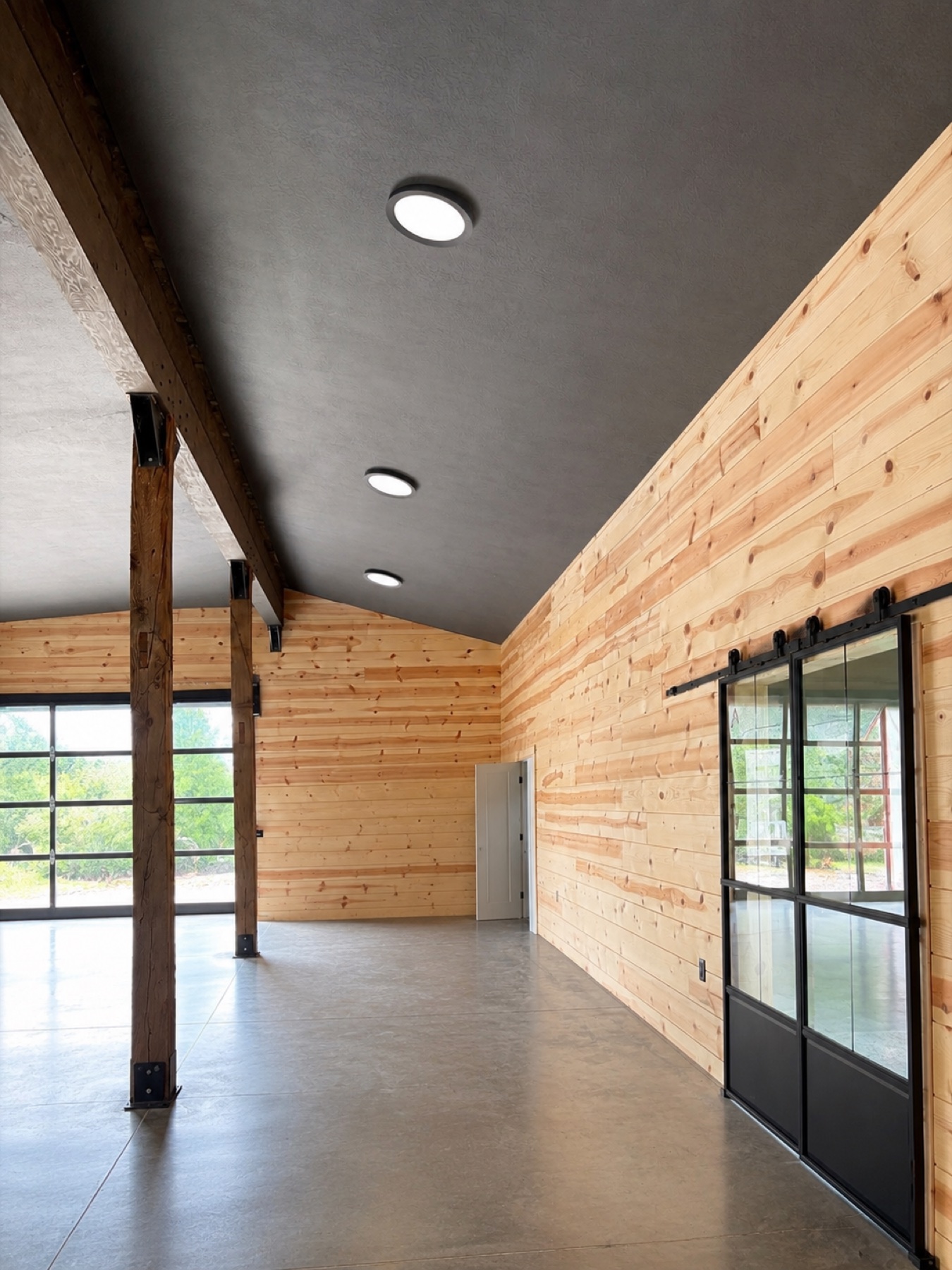 Wide view of completed wood-clad interior with polished concrete floor