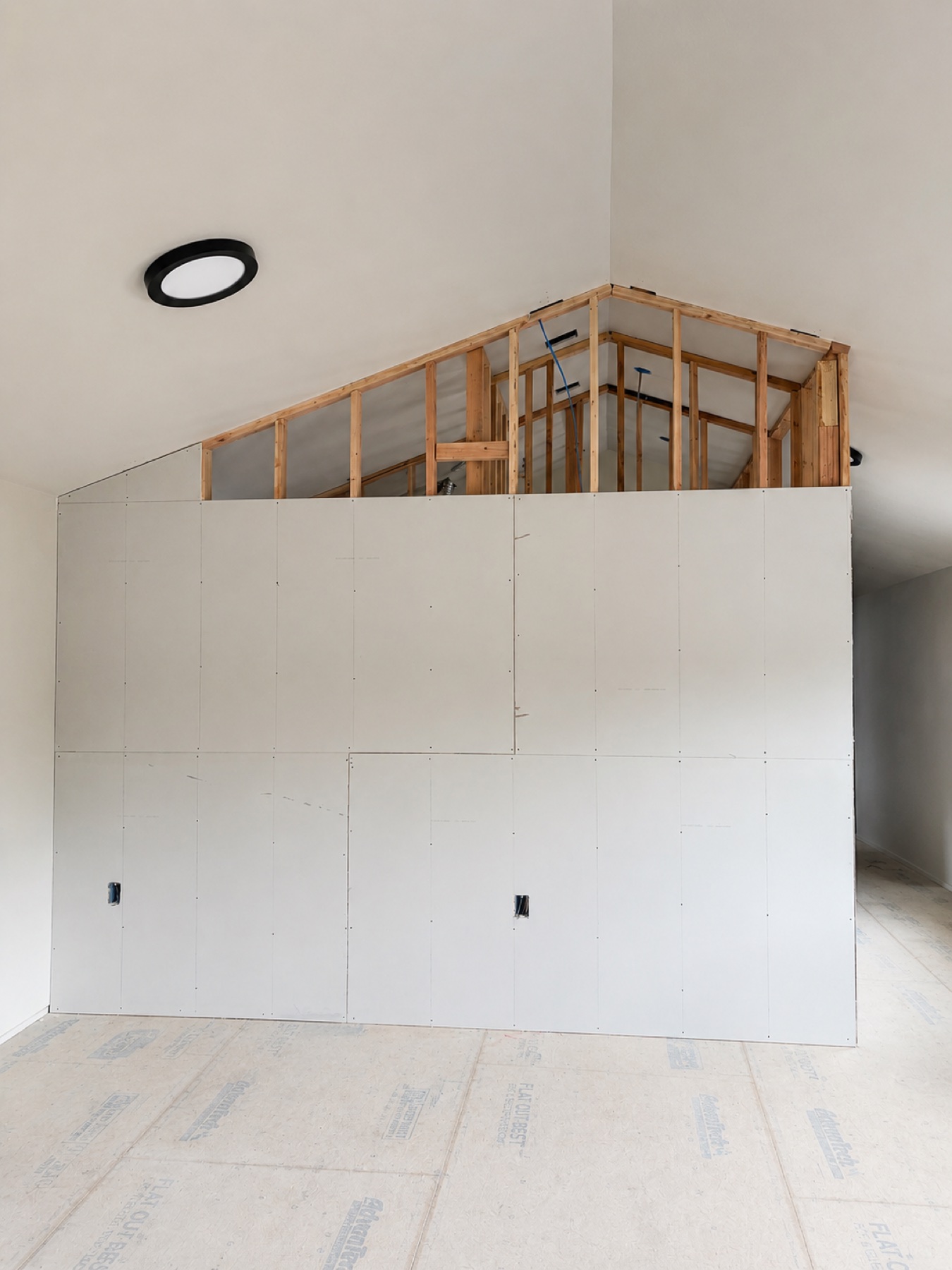 High-ceiling interior enclosure during drywall installation