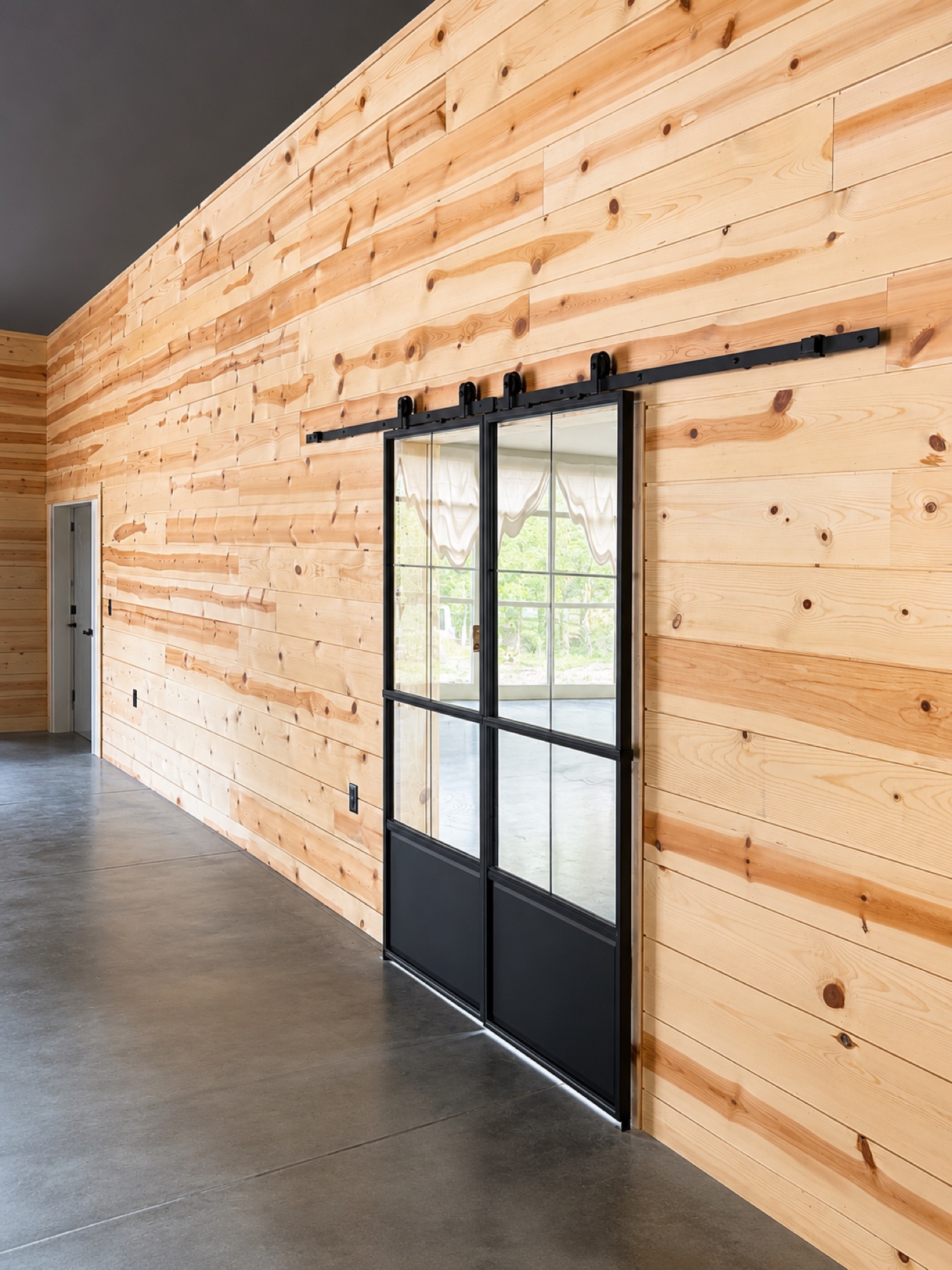 Angled view of wood wall and steel sliding doors